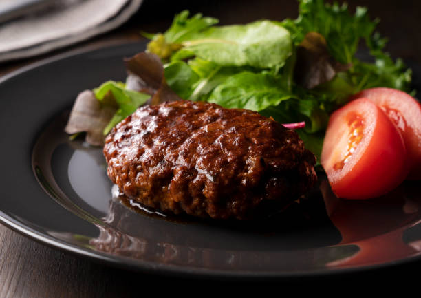 istock Hamburger with demi-glace sauce served on a plate placed on the table 1289992655