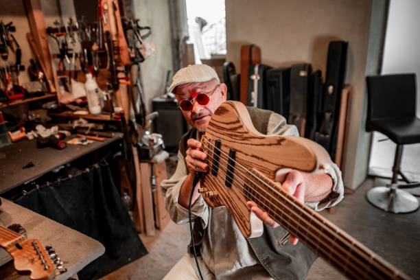 istock Italian Senior Man Checking a New Guitar in Workshop 1289993604