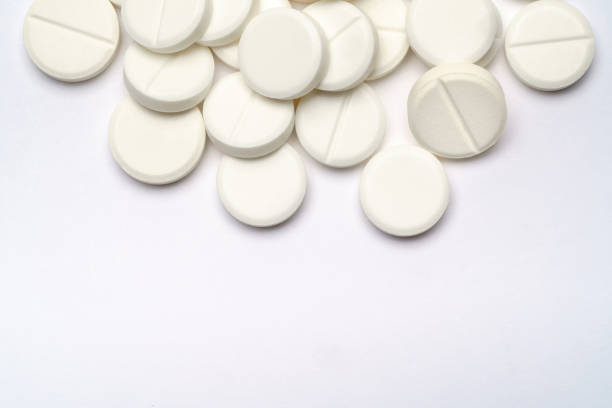 istock Heap of pills tablets over light grey background 1290000405