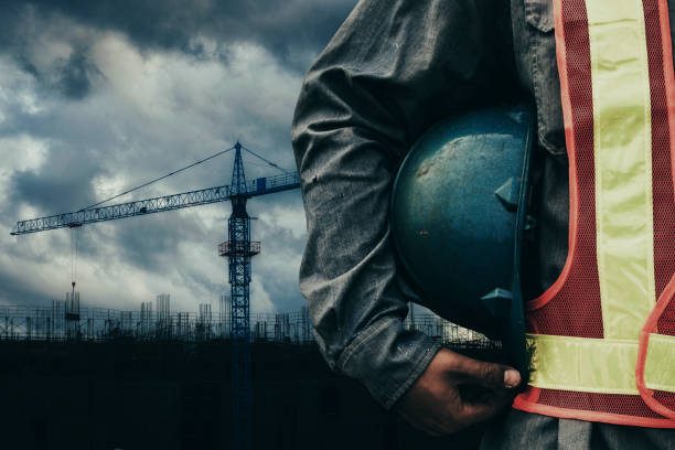 istock Man holding blue helmet close up 1290012016