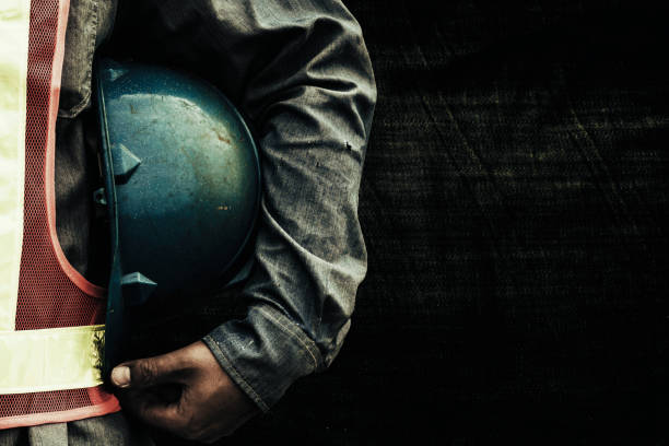istock Man holding blue helmet close up 1290012020