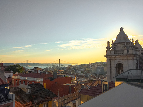 Lisbon rooftop view over the city and April 25th bridge at sunset landscaped photography Portugal