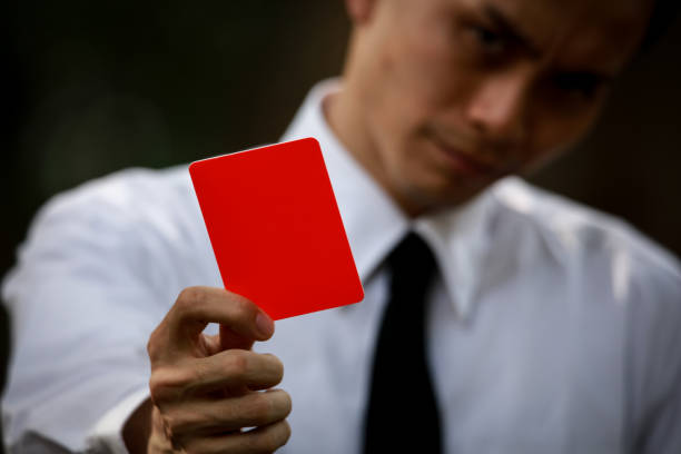istock Male employee issuing a red card 1290017355