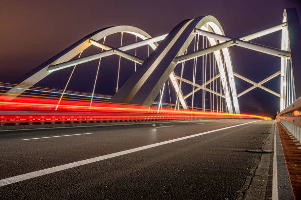 istock Highway speed traffic. Light trails effect at night 1290018190