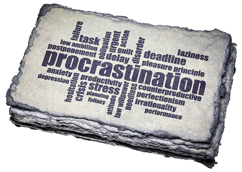 procrastination word cloud on a dark handmade paper, productivity and personal development concept
