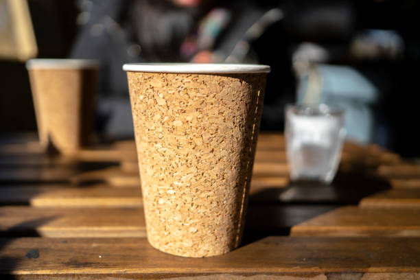 istock paper coffee cup on table in sunlight 1290018696