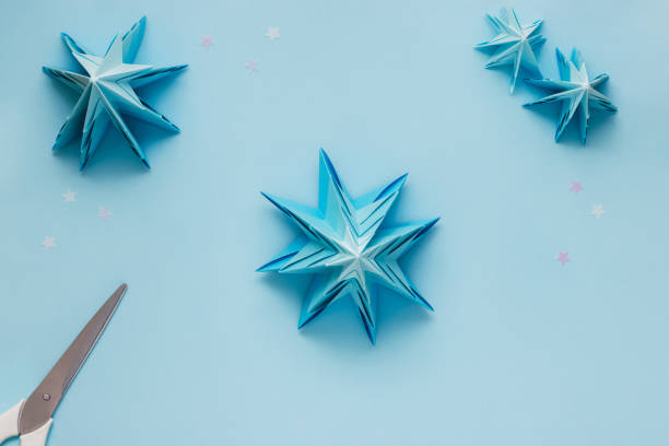istock Simple origami 3D Christmas tree made from blue paper. Step by step instruction, step 20 1290019395
