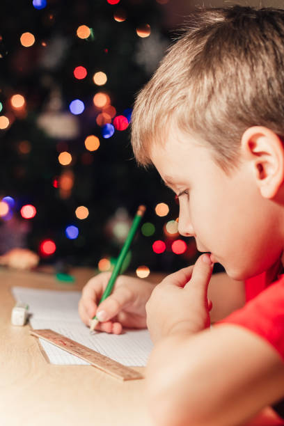 istock 7 yeas old boy sitting at desk and doing homework 1290019466