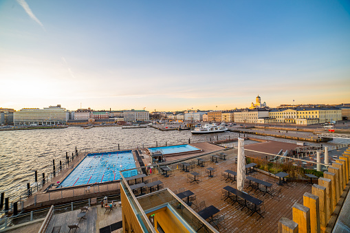 This pic shows Allas Sea Pool in Helsinki city centre in Finland. The pic is taken before sunset and sunset clouds, pool and some people can be seen in the pic. The pic is taken in helsinki finland.