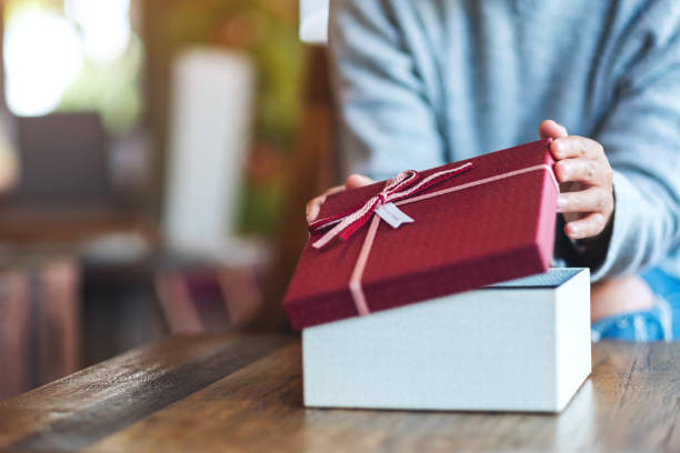 istock a woman opening a gift box 1290022447