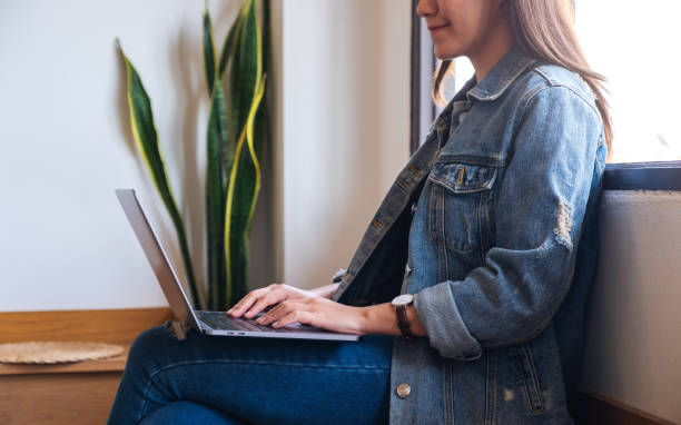 istock a beautiful young asian woman working and typing on laptop computer 1290022611
