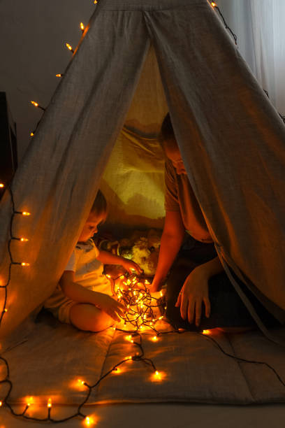 istock Magic tent with garland home, people inside. 1290028841