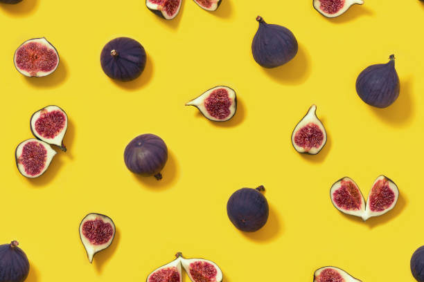 istock Colorful fresh figs fruit seamless pattern on bright yellow background, whole and sliced fig. 1290029506