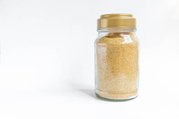 istock Brown sugar in clear glass bottle on white background 1290029561