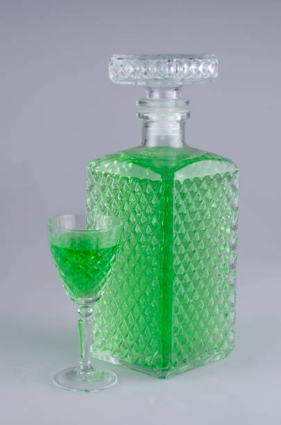 Decanter and sherry glass with green food dye