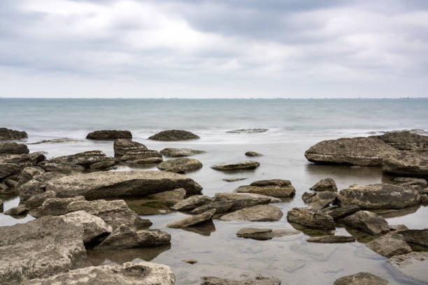 Long exposure, rocky sea beach at cloudy weather