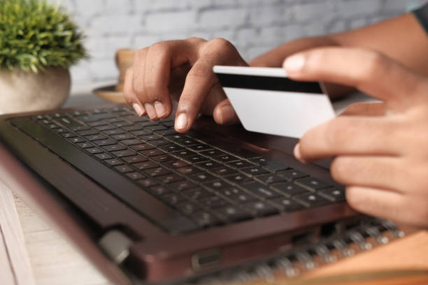 istock man hands holding credit card and using laptop shopping online 1290032183