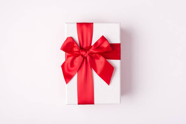 istock Top overhead close up view photo of rectangular present box tie with red light ribbon and bow isolated white color background 1290032377