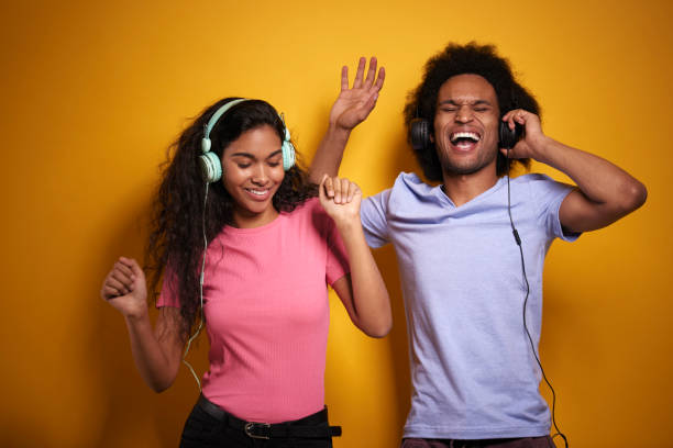 istock Two cheerful African people in headphones 1290032419