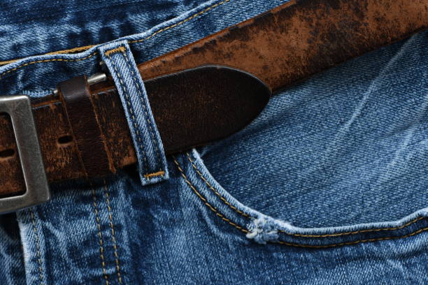 istock Blue jeans with old leather belt. 1290032783