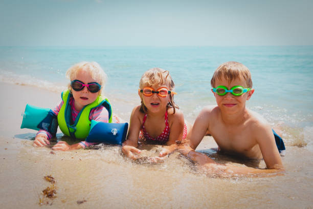 istock cute happy kids enjoy swim on beach 1290033428