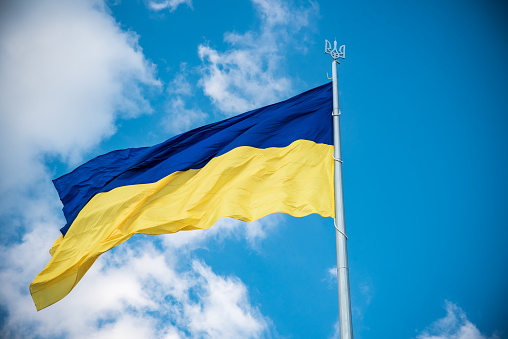 Ukrainian flag in the wind. Against the background of the sky.