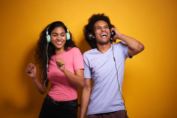 istock Couple having fun while listening to music 1290033966