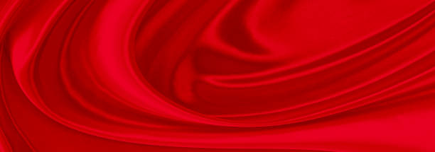 istock Black red satin dark fabric texture luxurious shiny that is abstract silk cloth background with patterns soft waves blur beautiful. 1290036685