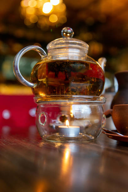 istock Chinese teapot with tea, on a burning support from glassChinese teapot with tea, on a burning support from glass 1290038643