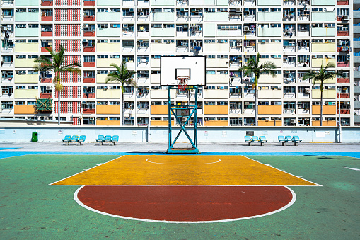 Colorful rainbow pastel building with basketball court and facade windows background. Architecture in Kowloon, Hong Kong City, China