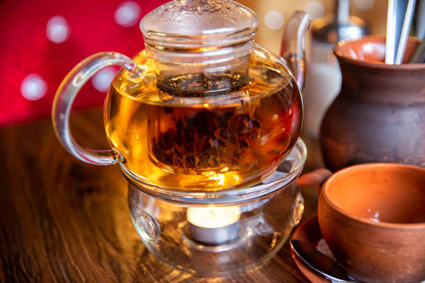 istock Chinese teapot with tea, on a burning support from glass 1290039722