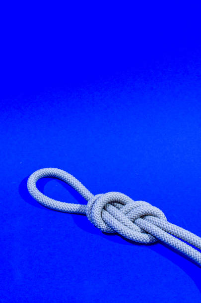 istock Knot with loop in front of blue background, portrait 1290039763
