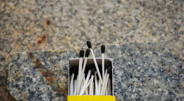 Close up of open single cardboard match box on granite stone background ,Box filled with tiny match sticks.