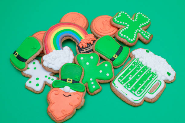 Top view of freshly baked St. Patrick's Day decorated sugar cookies on green background. stock photo