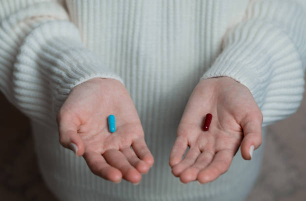 istock Hand holding to reveal two pills 1290043603
