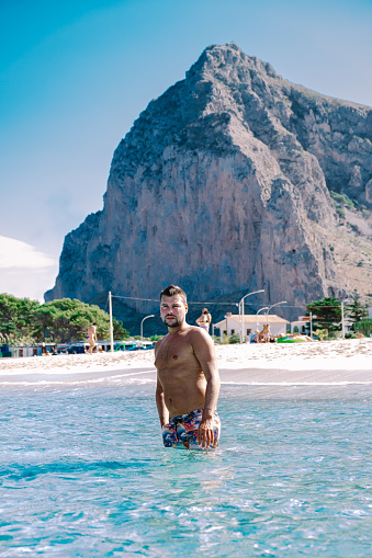 couple men and woman mid age on vacation at the Italian Island Sicily visiting the beach of San Vito Lo Capo. Sicilia Italy