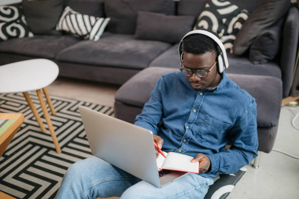 istock High angle view of a young African American male student studying from home using a laptop 1290045224