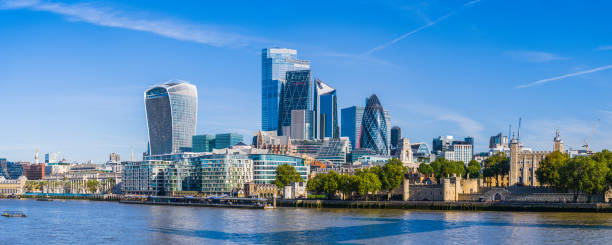 City of London skyscrapers overlooking Thames Embankment at Tower panorama The futuristic spires of City of London Square Mile financial district skyscrapers overlooking the River Thames Embankment and Tower of London, UK. bankside photos stock pictures, royalty-free photos & images