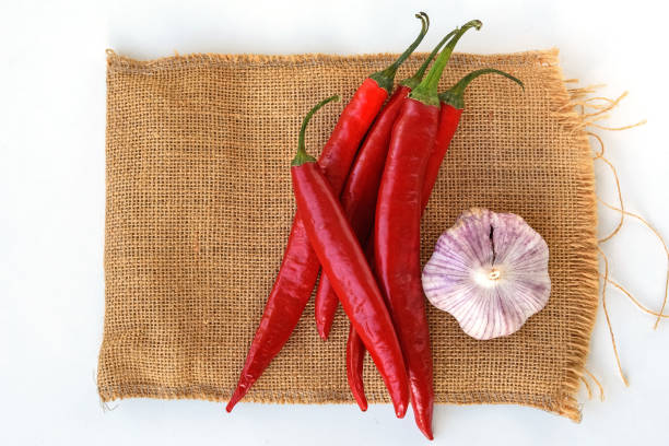 Hot red pepper and garlic on sackcloth on a white background. Close up.