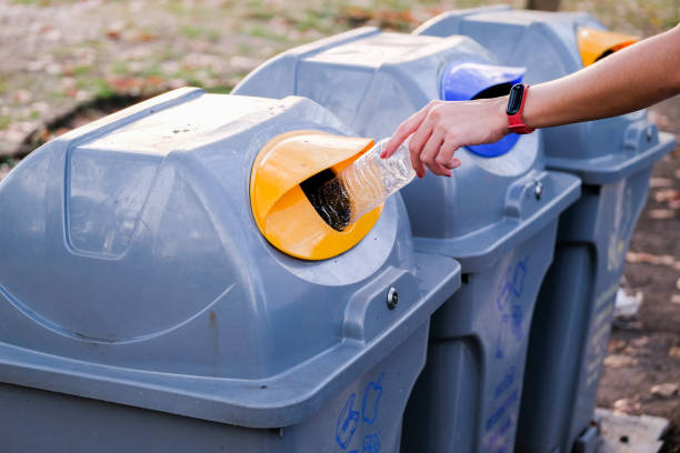 istock Selective focus. Recycle rubbish waste management people throwing plastic water bottle in the recycling garbage trash or bin, environmental recycling concept. 1290048385