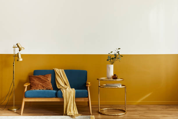 istock Unique living room in modern style interior with design sofa, elegant gold coffee table,copy space, flowers in vase, decoration and pesronal accessories in home decor. Template. 1290048754