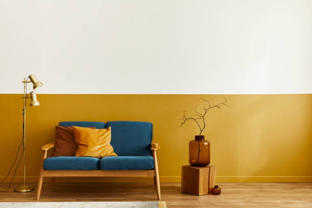 istock Unique living room in modern style interior with design sofa, elegant gold coffee table,copy space, flowers in vase, decoration and pesronal accessories in home decor. Template. 1290048842