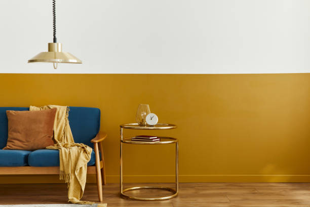 istock Unique living room in modern style interior with design sofa, elegant gold coffee table, mock up poster frames, flowers in vase, decoration and pesronal accessories in home decor. Template. 1290048846