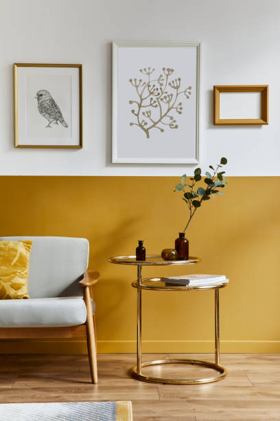 istock Unique living room in modern style interior with design sofa, elegant gold coffee table, mock up poster frames, flowers in vase, decoration and pesronal accessories in home decor. Template. 1290048848