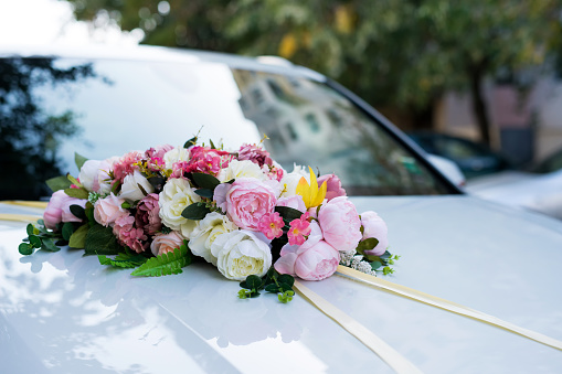 Wedding car.Wedding decoration on wedding car.Luxury wedding car decorated with flowers - selective focus, copy space