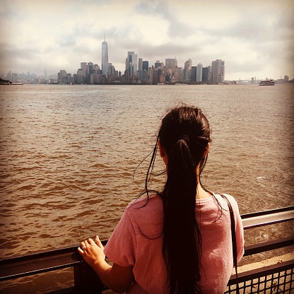 Image of a woman looking the skyline of Manhattan