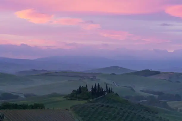 Photo of Colorful sunrise over the small Belvedere village nestled in the fantastic Val d'Orcia in Tuscany