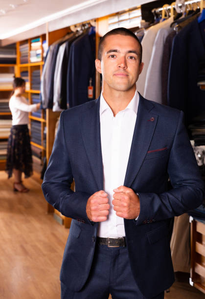 istock Man trying on new suit in store 1290058022