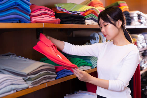 istock Girl choosing polo shirt 1290058037