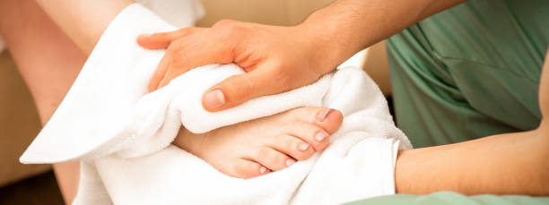 istock Masseur wiping the woman's legs 1290062077